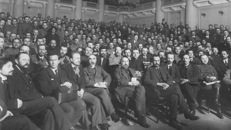 The delegates of the First All-Russian convocation of Soviets of workers and military delegates in a hall of Tauride Palace. There are Nikolay S. Chkheidze (6th from the left), Georgiy V. Plekhanov (5th from the left) among the delegates. 4–28 May 1917. The photo is in the archives in Saint-Petersburg